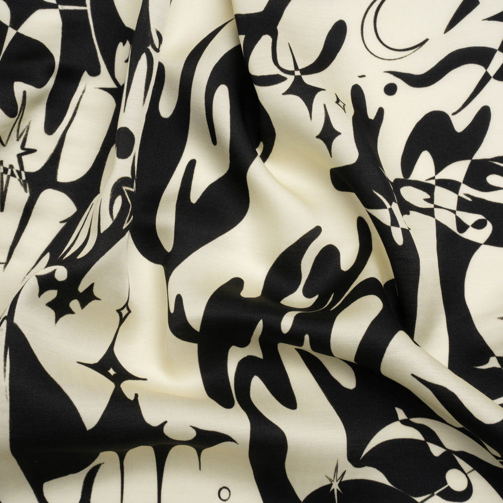 Sustainable and Recycled Viscose Satin Print - Cream and Black Abstract and Stars - Mood Exclusive Cosmic Chaos Sustainable and Recycled Viscose Satin Print - Cream and Black Abstract and Stars - Mood Exclusive Cosmic Chaos