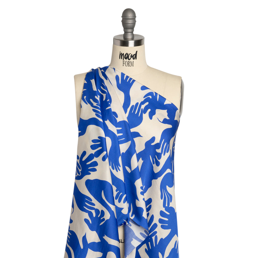 Sustainable and Recycled Viscose Satin Print - Blue and White Hands - Mood Exclusive Helping Hands Detail Sustainable and Recycled Viscose Satin Print - Blue and White Hands - Mood Exclusive Helping Hands Detail