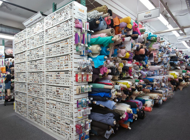 Many stuffed animals on display in a store