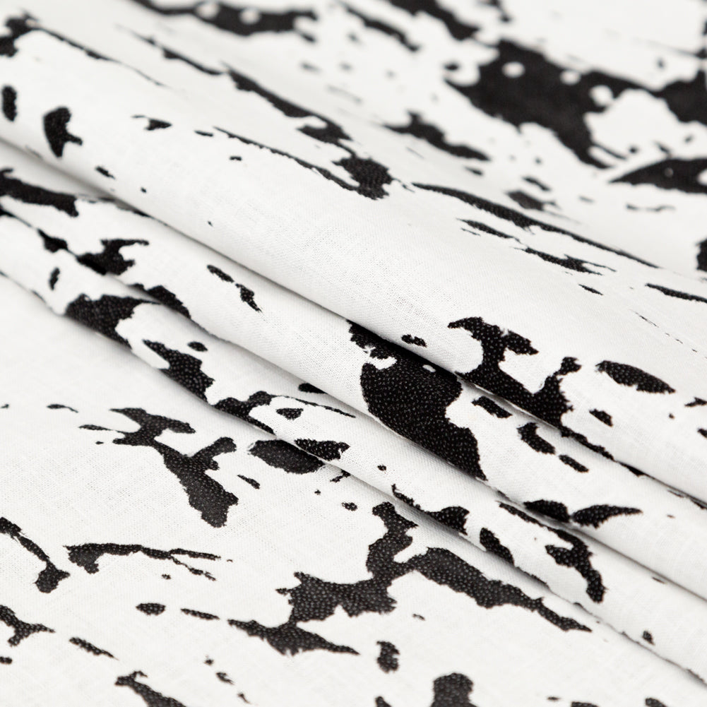 White and Black Abstract Burnout Polyester Woven with Fused Backing Folded