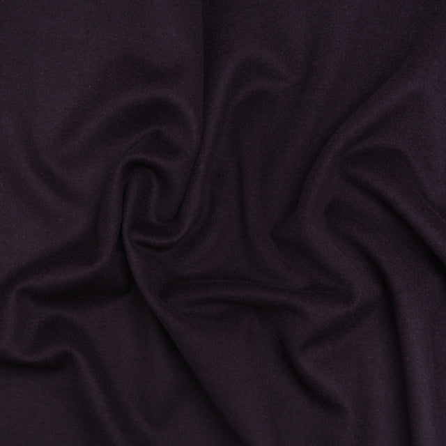A close up of a purple fabric with a very long design