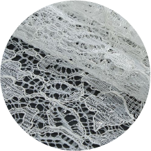 A close up of a white lace on a black background