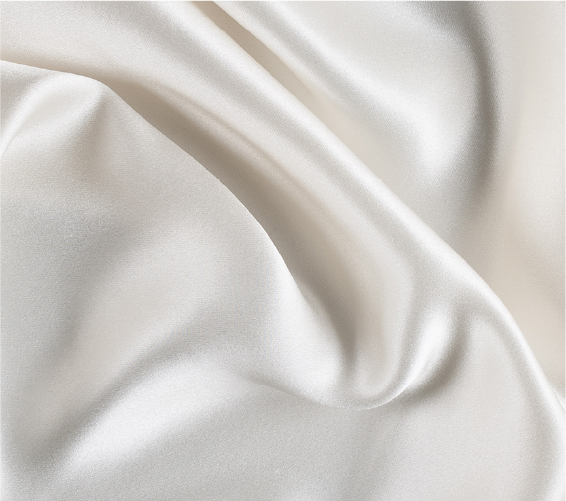 A close up of a white fabric with a very long line of folds