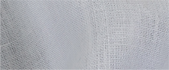 A close up of a white fabric with a pattern of small dots