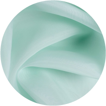 A close up of a green fabric with a white background