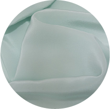 A close up of a white cloth with a green background