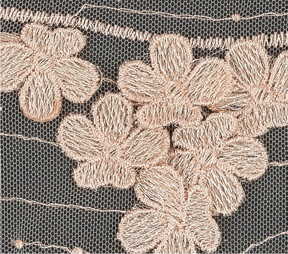A close up of a black and white floral design on a sweater