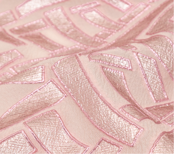 A close up of a pink fabric with a design on it