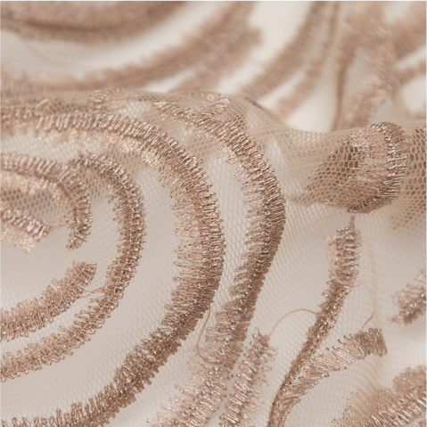 A close up of a beige and white fabric with a swirl design