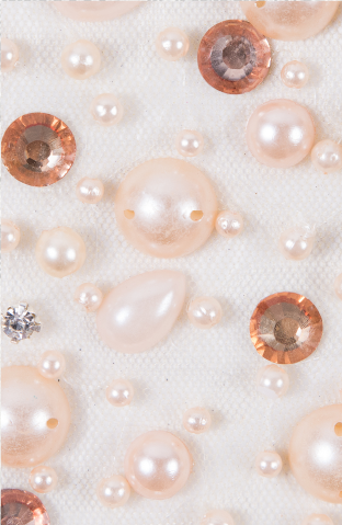 Many pearls and other jewels on a white cloth