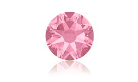 A close up of a pink diamond on a white surface