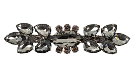 A close up of a black and white brooch with crystal stones