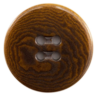 A close up of a button with a wooden surface