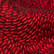 A close up of a red fabric with a black pattern