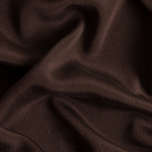 A close up of a brown fabric with a white background