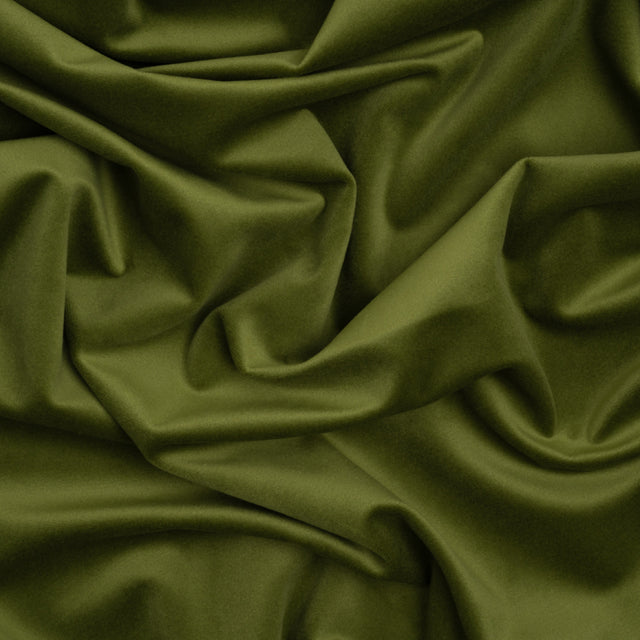 A close up of a green fabric with a very large amount of folds