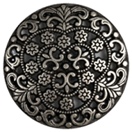 A close up of a metal button with a flower design