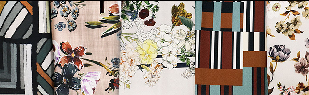 Many different fabrics hanging on the wall