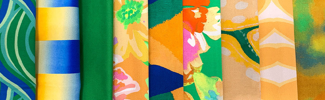 A close up of a bunch of different colored ties on a table