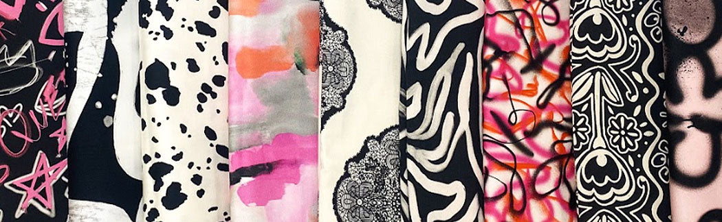 A close up of a bunch of different colored scarves hanging on a wall
