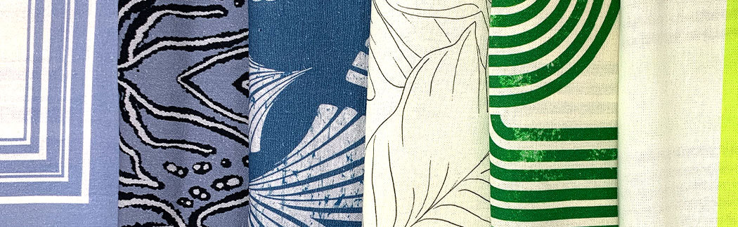 A close up of a variety of different colored ties on a table
