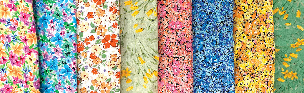 A close up of a bunch of colorful fabrics on a table