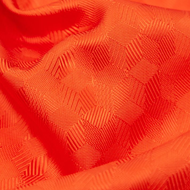 A close up of a red fabric with a pattern on it