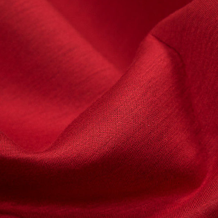 A close up of a red fabric with a very thin pattern