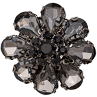 A close up of a black and white flower brooch