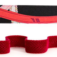 A close up of a red belt with a red ribbon