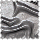 A close up of a silver fabric with a black background