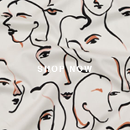 A close up of a white fabric with a drawing of a woman ' s face