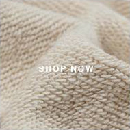 A close up of a knitted blanket with a white background