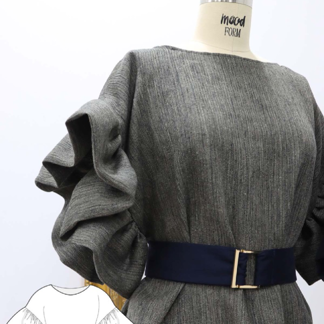 A close up of a dress with a belt on a mannequin