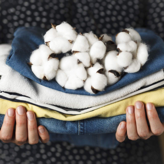 Pile of cotton on a pile of folded towels