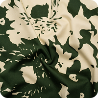 A close up of a green and white floral print fabric
