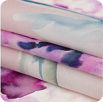 A close up of a stack of four sheets of fabric