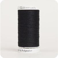 A spool of black thread with a white label on it