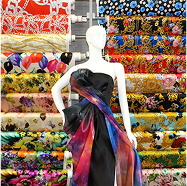 Mannequin in a dress and scarf in front of a display of fabrics
