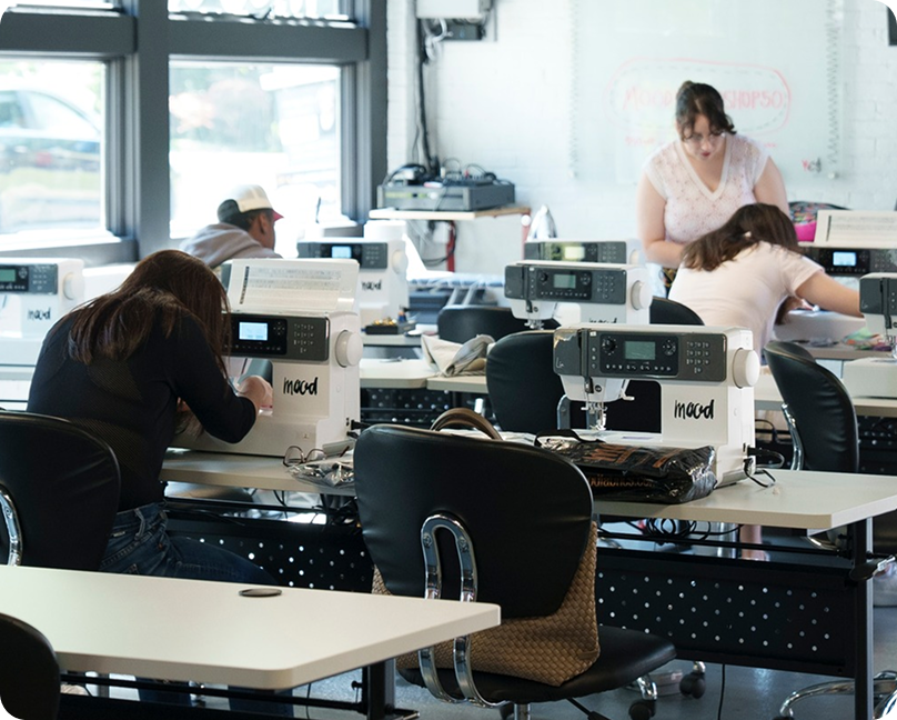 Two women working on computers in a large room