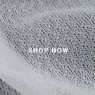 A close up of a gray mesh fabric with a white logo