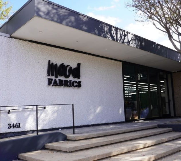 Building with a sign that says wood fabrics