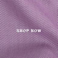A close up of a purple shirt with a white logo on it